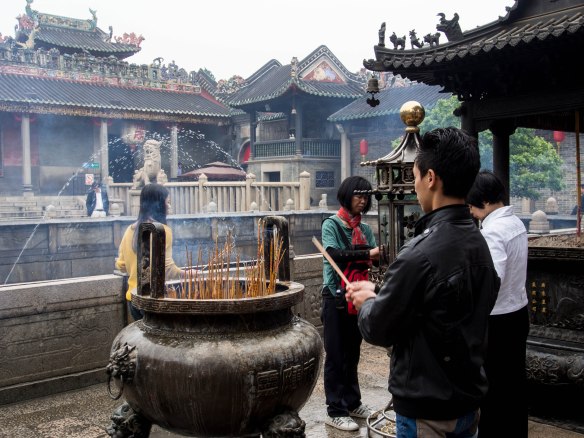 Worshippers burning incense 