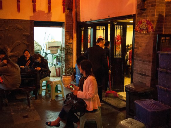 People waiting outside in the courtyard.