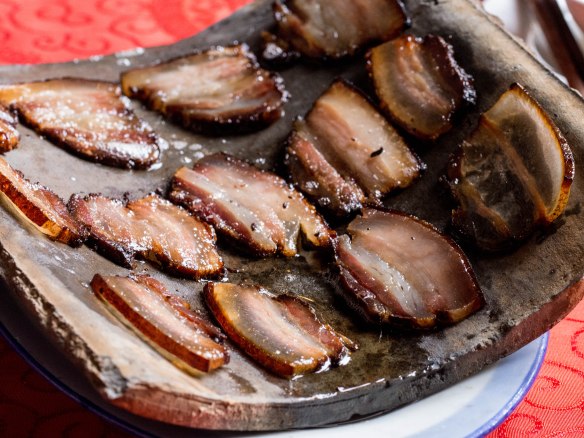 Pork on a hot curved tile.